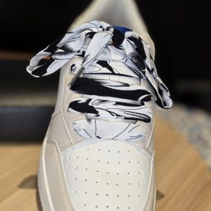 Artistic doodle flower handmade shoelaces styled on casual sneakers.